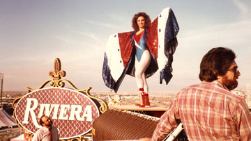 An image from Glow showing a female wrestler posing on a rooftop