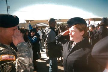 An image from The Invisible War showing a male and female soldier saluting