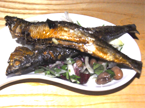 Pan fried sardines on a bed of beans