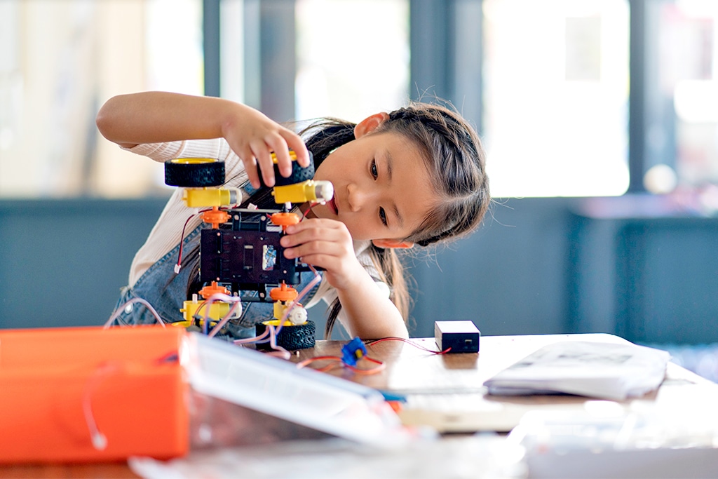 Girl building a robot