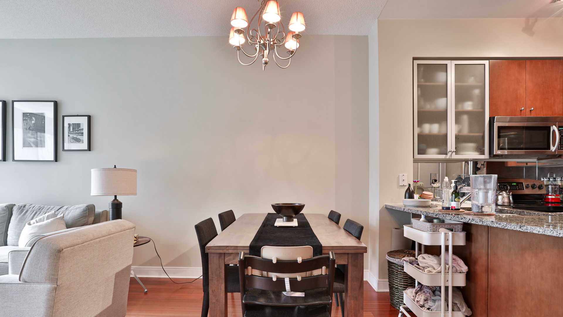 A photo of the dining table and chandelier.