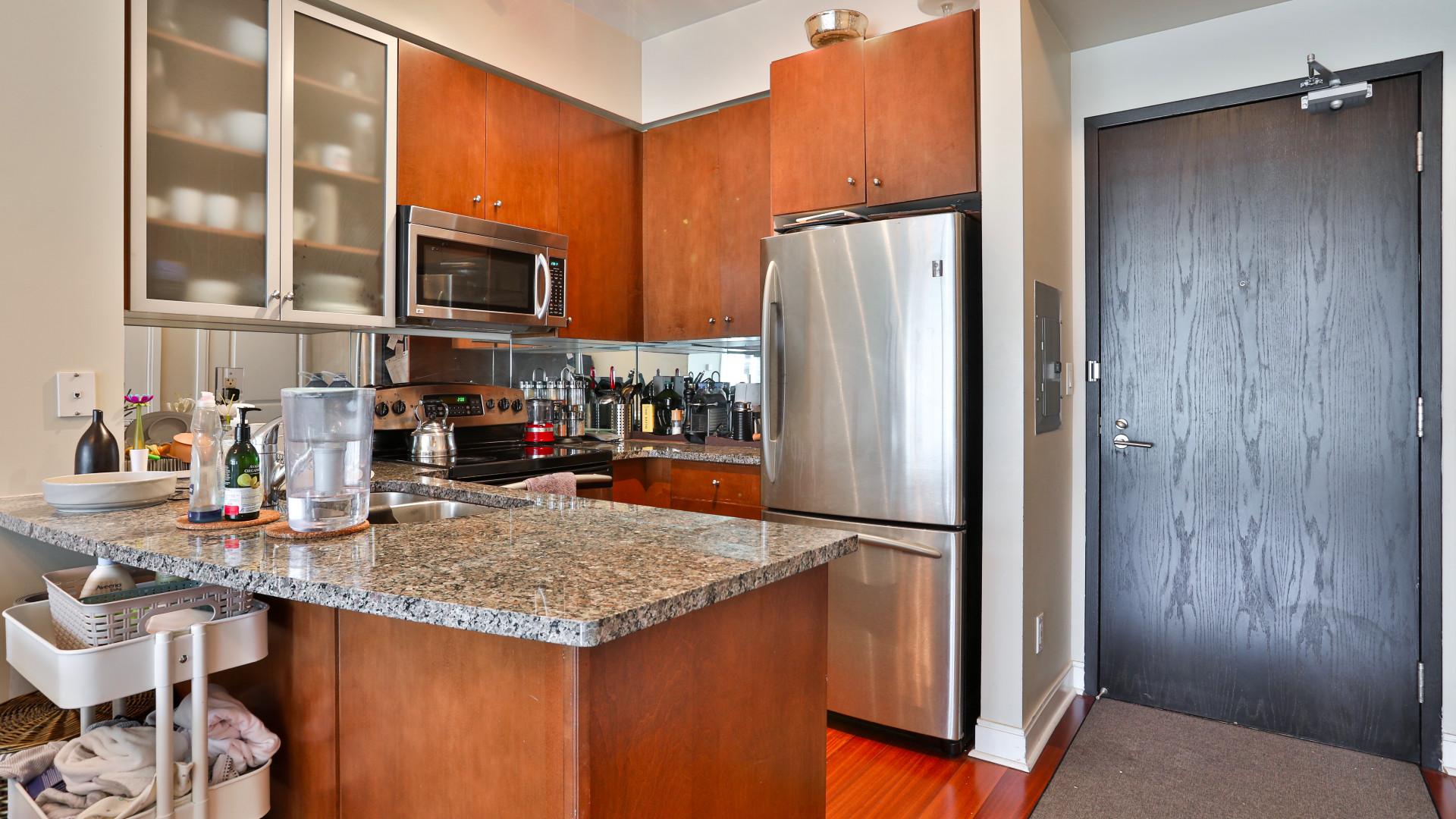 A photo of the kitchen area with granite countertops.
