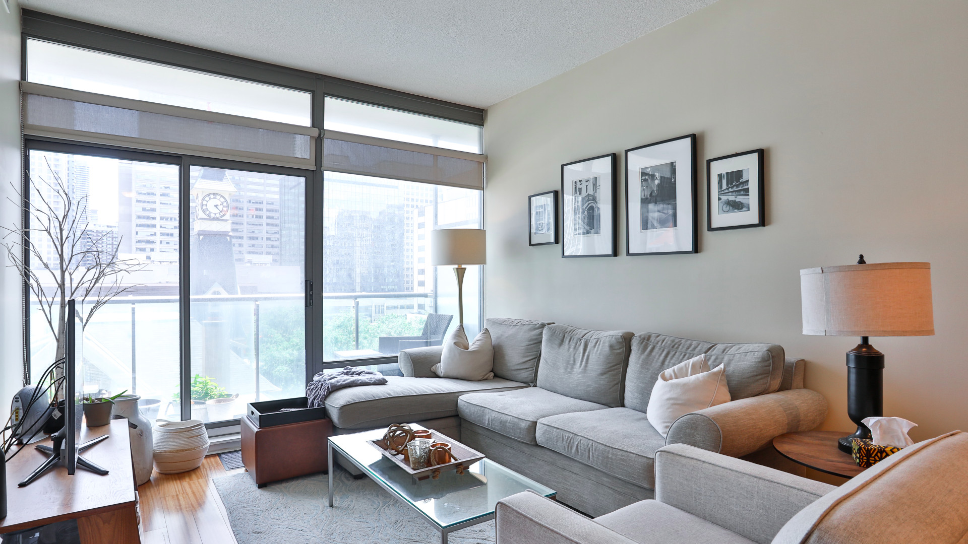 A photo of the living room and floor-to-ceiling windows.