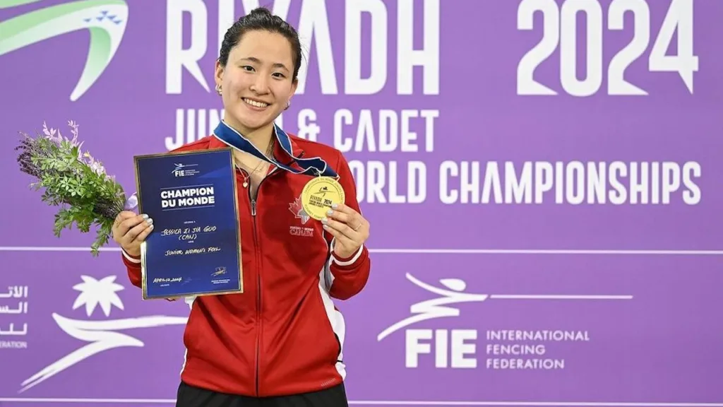 Fencer Jessica Guo stands holding a gold medal at the 2024 FIE Junior World Championships