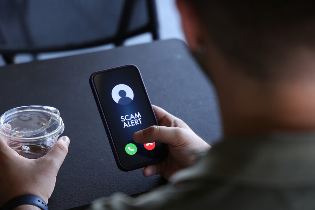 Scam alert on mobile phone screen
